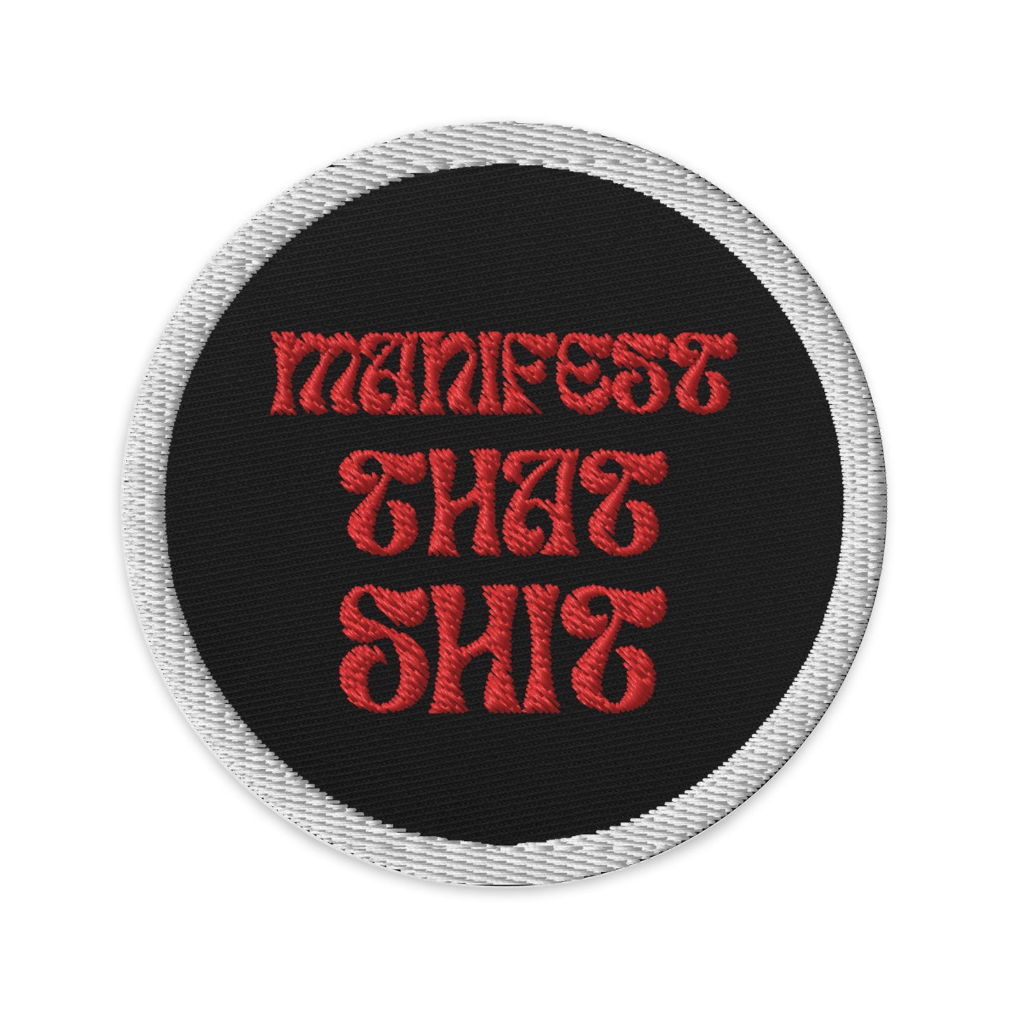 Embroidered patches that say Manifest that Shit. Black with red writing