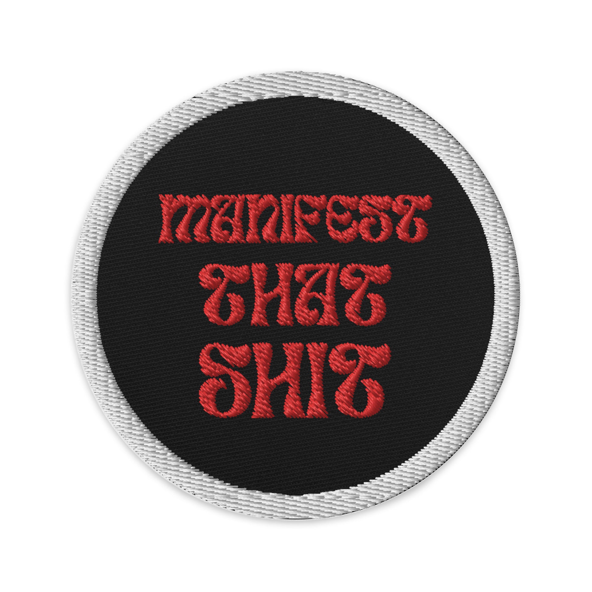 Embroidered patches that say Manifest that Shit. Black with red writing